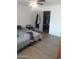 Bright bedroom with wood-look floors and an open closet, providing ample storage space at 610 E Estevan Ave, Apache Junction, AZ 85119