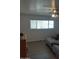 Bedroom featuring wood-look floors, a ceiling fan and a large window with plenty of natural light at 610 E Estevan Ave, Apache Junction, AZ 85119