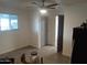Bedroom featuring gray flooring, a ceiling fan and a walk-in closet at 610 E Estevan Ave, Apache Junction, AZ 85119