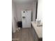 Kitchen features a large white refrigerator with a water dispenser and light wood-look vinyl flooring at 610 E Estevan Ave, Apache Junction, AZ 85119