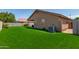 Well-maintained backyard with green artificial grass and a covered patio area, perfect for outdoor living at 672 S Porter St, Gilbert, AZ 85296