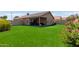 Spacious backyard with artificial grass and a covered patio, ideal for outdoor activities and gatherings at 672 S Porter St, Gilbert, AZ 85296