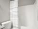 Clean bathroom featuring a neutral shower curtain and a white tub at 672 S Porter St, Gilbert, AZ 85296