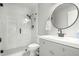 Stylish bathroom features a walk-in shower with matte black hardware and a grey vanity with round mirror at 672 S Porter St, Gilbert, AZ 85296