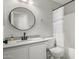 Well-lit bathroom with white cabinets, grey countertop and black hardware at 672 S Porter St, Gilbert, AZ 85296
