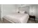 Comfortable bedroom featuring neutral tones, stylish lamps, and a soft upholstered headboard at 672 S Porter St, Gilbert, AZ 85296