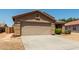 Exterior view of a home showcasing a two-car garage and desert landscaping in a quiet neighborhood at 672 S Porter St, Gilbert, AZ 85296