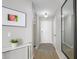 Inviting hallway with new flooring, modern lighting, decor, and access to other areas of the home at 672 S Porter St, Gilbert, AZ 85296