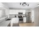 Modern kitchen features white cabinets, stainless steel appliances, and plenty of counter space at 672 S Porter St, Gilbert, AZ 85296