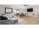 Bright and spacious living room featuring hardwood floors, a ceiling fan, and sliding doors to backyard at 672 S Porter St, Gilbert, AZ 85296