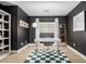 Home office with stylish, dark walls, natural light, modern desk and a decorative checkered rug at 672 S Porter St, Gilbert, AZ 85296