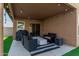 Covered patio with a barbecue grill and seating, perfect for enjoying outdoor meals and relaxation at 672 S Porter St, Gilbert, AZ 85296