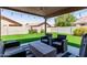Outdoor patio area with a black and white rug and seating arrangement, great for entertaining guests at 672 S Porter St, Gilbert, AZ 85296