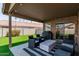 Covered patio featuring string lights and a seating area with comfortable chairs and a grill at 672 S Porter St, Gilbert, AZ 85296