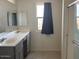 Modern bathroom with dual sinks, gray cabinetry, and a walk-in shower at 7227 N 125Th Dr, Glendale, AZ 85307