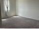 Cozy bedroom with neutral carpet, a window, and natural light at 7227 N 125Th Dr, Glendale, AZ 85307