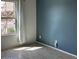 Well-lit room with wood-look floors, a colorful accent wall, and a bright window at 7227 N 125Th Dr, Glendale, AZ 85307