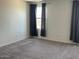 Spacious bedroom with neutral carpet and dark curtains for a cozy atmosphere at 7227 N 125Th Dr, Glendale, AZ 85307