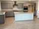 Spacious kitchen featuring an island and modern appliances, perfect for cooking at 7227 N 125Th Dr, Glendale, AZ 85307