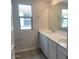Bathroom features a double vanity with white cabinets, and a framed mirror at 7244 E Hackamore Ln, San Tan Valley, AZ 85143