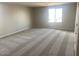 Bright, carpeted bedroom features a large window for ample light, creating a cozy and inviting atmosphere at 7244 E Hackamore Ln, San Tan Valley, AZ 85143
