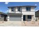 Charming two-story home with a well-maintained front yard and a two-car garage, perfect for a growing Gathering at 7244 E Hackamore Ln, San Tan Valley, AZ 85143