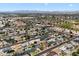 Expansive aerial shot of a sprawling residential area boasting a mix of housing styles, mature trees, and well-maintained streets at 7502 E Princeton Ave, Scottsdale, AZ 85257