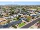 Stunning aerial view showcasing a vibrant residential neighborhood with lush greenery, manicured lawns, and a community pool at 7502 E Princeton Ave, Scottsdale, AZ 85257