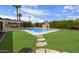 Lush backyard features pool, grass, and outdoor BBQ, perfect for entertaining at 7502 E Princeton Ave, Scottsdale, AZ 85257