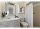 Bright bathroom featuring a white vanity, framed mirror, toilet, and a shower with a white curtain at 7502 E Princeton Ave, Scottsdale, AZ 85257