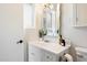 Bathroom showcasing a white vanity, framed mirror, faucet, and toilet accessories at 7502 E Princeton Ave, Scottsdale, AZ 85257