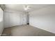 Bedroom features carpet, a ceiling fan, and white closet doors at 7502 E Princeton Ave, Scottsdale, AZ 85257