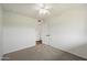 Bedroom boasts neutral carpet, a ceiling fan, and an entry door at 7502 E Princeton Ave, Scottsdale, AZ 85257