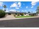 Charming single story home featuring a well-manicured front lawn and mature palms at 7502 E Princeton Ave, Scottsdale, AZ 85257