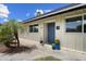 Inviting home entrance with well-kept landscaping, potted plants and a secure, stylish front door at 7502 E Princeton Ave, Scottsdale, AZ 85257