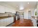 Bright kitchen features stainless steel appliances, white cabinetry and tile flooring with an open view of the backyard pool at 7502 E Princeton Ave, Scottsdale, AZ 85257