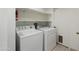Bright laundry room with modern appliances and built in shelving at 7502 E Princeton Ave, Scottsdale, AZ 85257