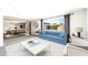 Bright living room with pool view, modern furniture, and open layout to the dining area at 7502 E Princeton Ave, Scottsdale, AZ 85257