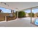 Open-air patio features stone barbecue and a refreshing pool nearby at 7502 E Princeton Ave, Scottsdale, AZ 85257
