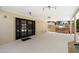 Covered outdoor patio with dark-framed glass doors and a built-in barbecue at 7502 E Princeton Ave, Scottsdale, AZ 85257