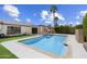 Backyard featuring a sparkling pool, covered patio with grill, green grass and mature landscaping at 7502 E Princeton Ave, Scottsdale, AZ 85257