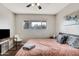 Cozy bedroom features a ceiling fan, window, desk, and comfortable bed at 7520 E Papago Dr, Scottsdale, AZ 85257