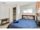 This bedroom features a blue bedspread, closet and light-colored tile at 7520 E Papago Dr, Scottsdale, AZ 85257