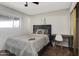 Relaxing bedroom features a window, desk, and soft gray bedding at 7520 E Papago Dr, Scottsdale, AZ 85257