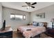 Bedroom with ceiling fan, window, and comfortable bed at 7520 E Papago Dr, Scottsdale, AZ 85257