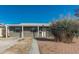 Single-story home featuring a covered entry and desert landscaping, offering a welcoming facade at 7520 E Papago Dr, Scottsdale, AZ 85257