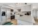 Bright kitchen features stainless steel appliances, white cabinets, and light countertops at 7520 E Papago Dr, Scottsdale, AZ 85257