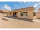 Desert landscaped backyard with covered patio, block walls, and paver extension at 7916 W Mary Ann Dr, Peoria, AZ 85382