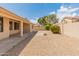 Backyard with desert landscaping, block wall, and covered patio area at 7916 W Mary Ann Dr, Peoria, AZ 85382