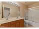 Bathroom with dual sinks, tile floors, large mirror, and glass-enclosed shower at 7916 W Mary Ann Dr, Peoria, AZ 85382